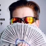 Image of man fanning one hundred dollar bills with the question, Why does your business exist?